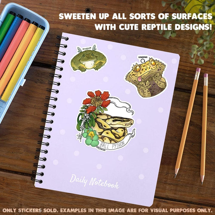 Image shows top down view of notebook with stickers sold by Fatty Pancake on the cover. Stickers for sale only.