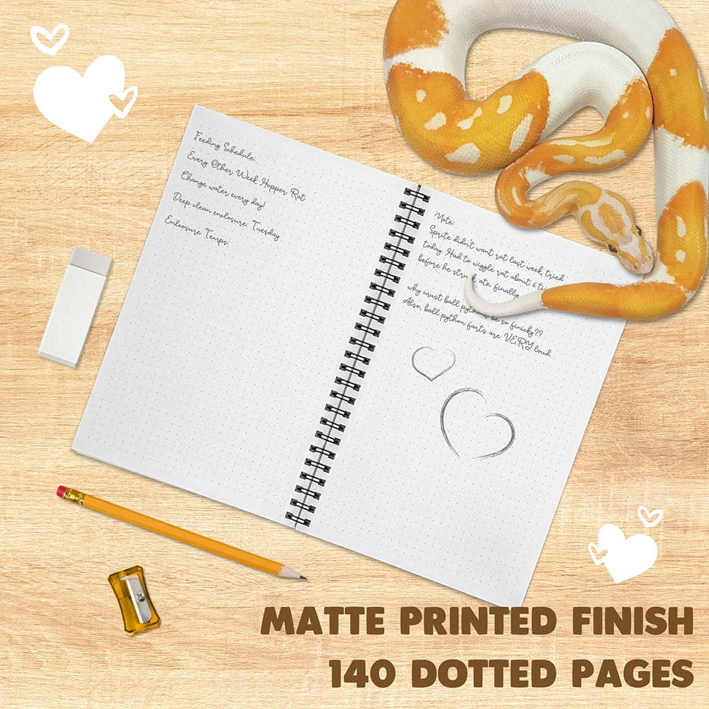 An open spiral notebook with a matte white page shown on a light wood background, styled with a yellow-and-white snake, pencil, eraser, and sharpener. Text at the bottom reads &