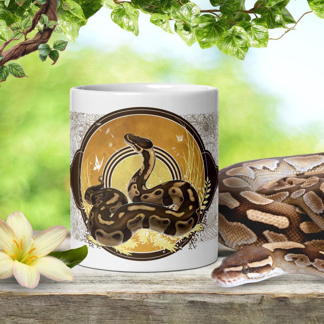 A white ceramic 11oz mug with a Ball Python snake design on a natural background.