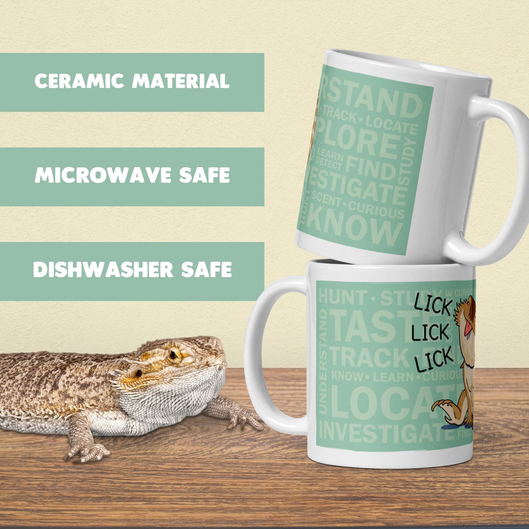 Two ceramic mugs with a mint green with lots of text are displayed on a wooden surface against a beige background. A bearded dragon is pictured on the left, and text on the left highlights product features: &