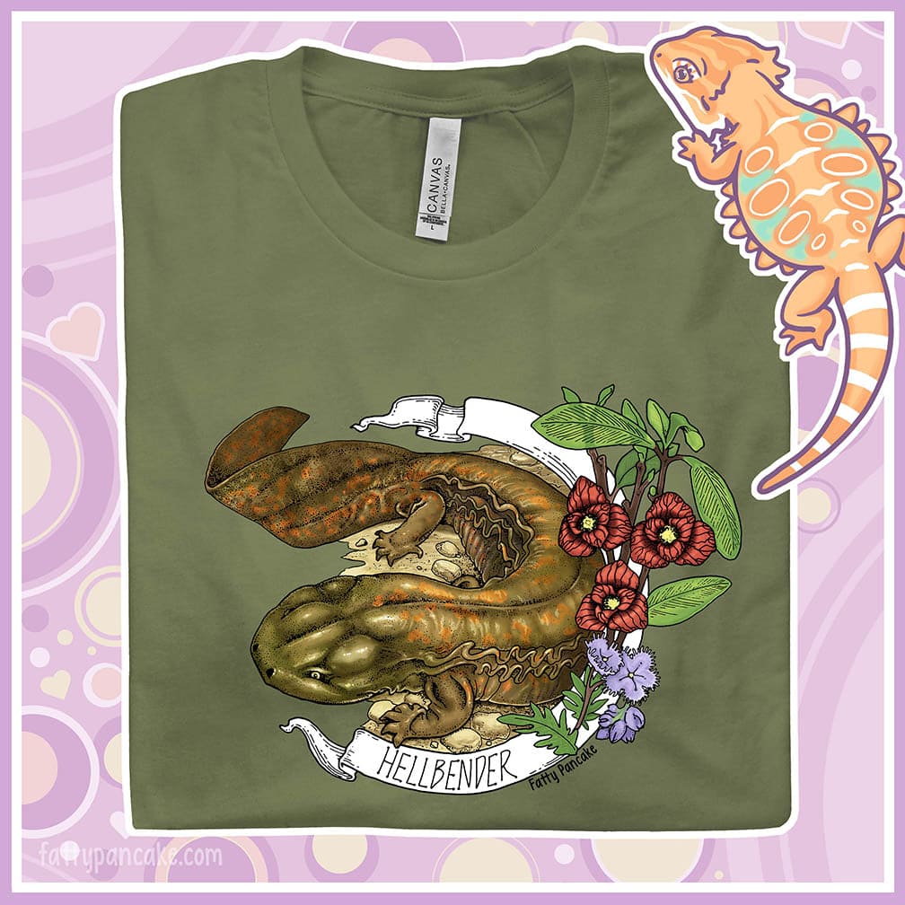 Image depicts folded crew neck tee with a hand drawn design of a hellbender amphibian framed by paw paw flowers and a banner that says, "Hellbender".