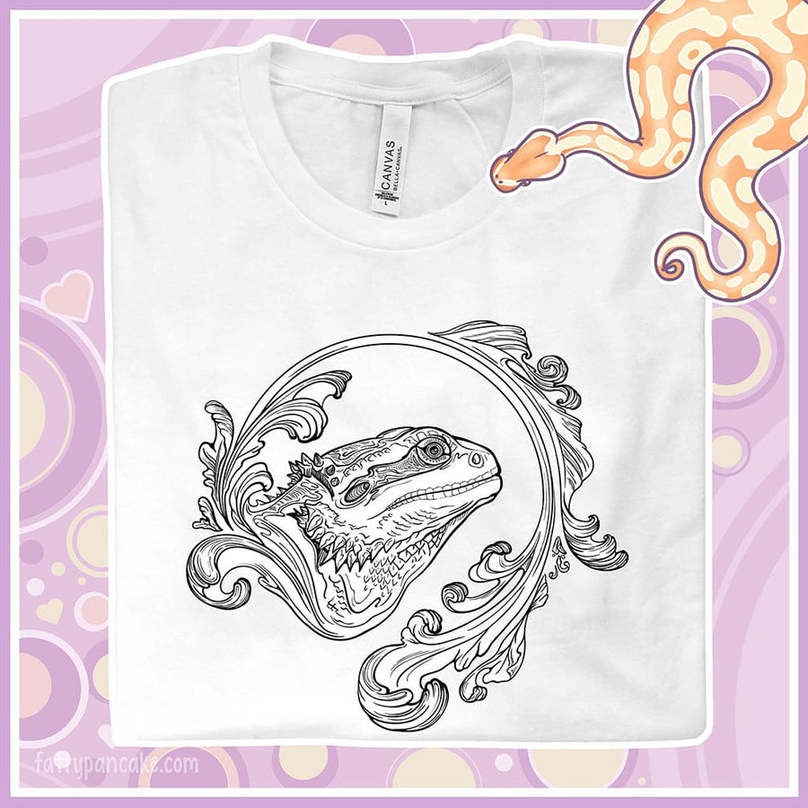 Folded white crew neck tee showing an elegant design of a bearded dragon with a swooshing flourish design.