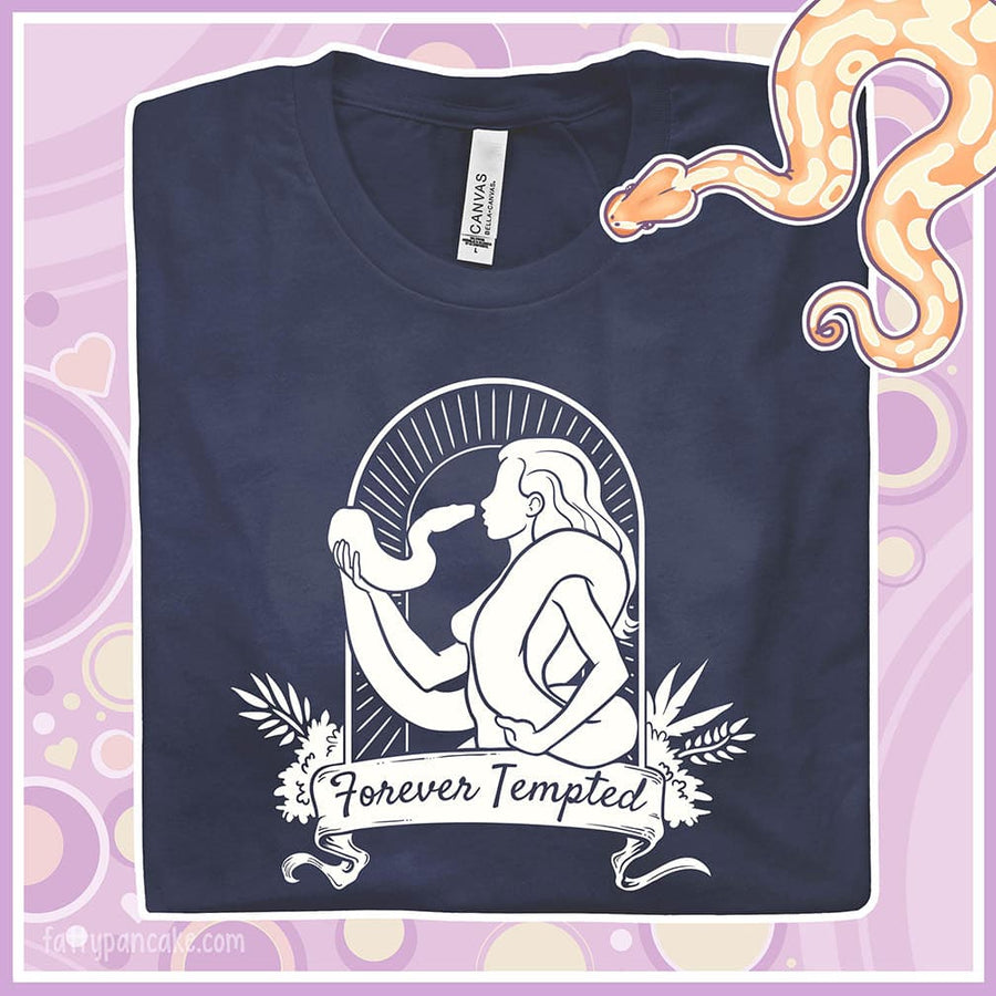 A folded navy crew neck tee with a silhouette of a woman holding a snake and text saying "Forever Tempted".