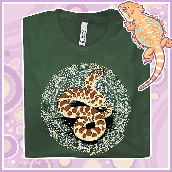 A folded forest green colored crew neck tee with a Western Hognose snake in the center of a circular design with many embellishments.