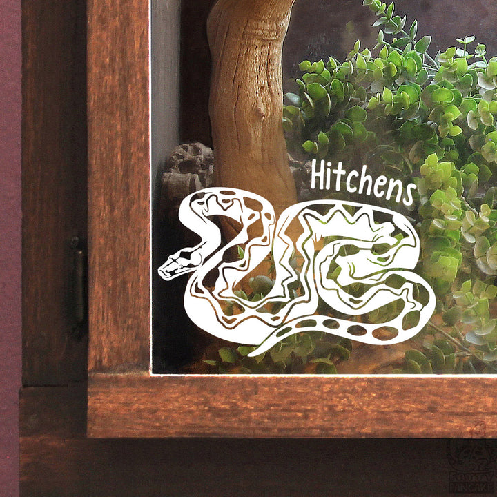 A white vinyl decal of a coiled Boa Sigma snake with the name &