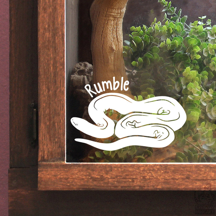 A white vinyl decal of a coiled Rubber Boa snake with the name &