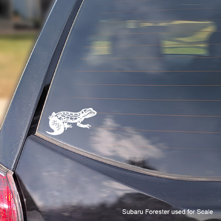 A white vinyl decal of a Viper Gecko lizard applied to the rear window of a dark-colored car, shown for scale with Subaru Forester text in the bottom right corner.
