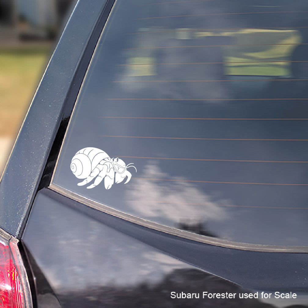 White hermit crab decal on a car window with 'Subaru Forester used for scale' text.