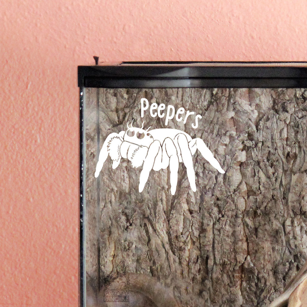 Glass container with a white jumping spider vinyl decal design and 'Peepers' text on a pink background.