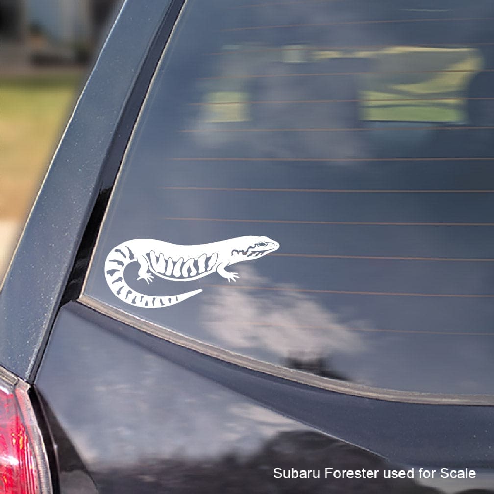 White fire skink  lizard decal on a car window with 'Subaru Forester used for scale' text.