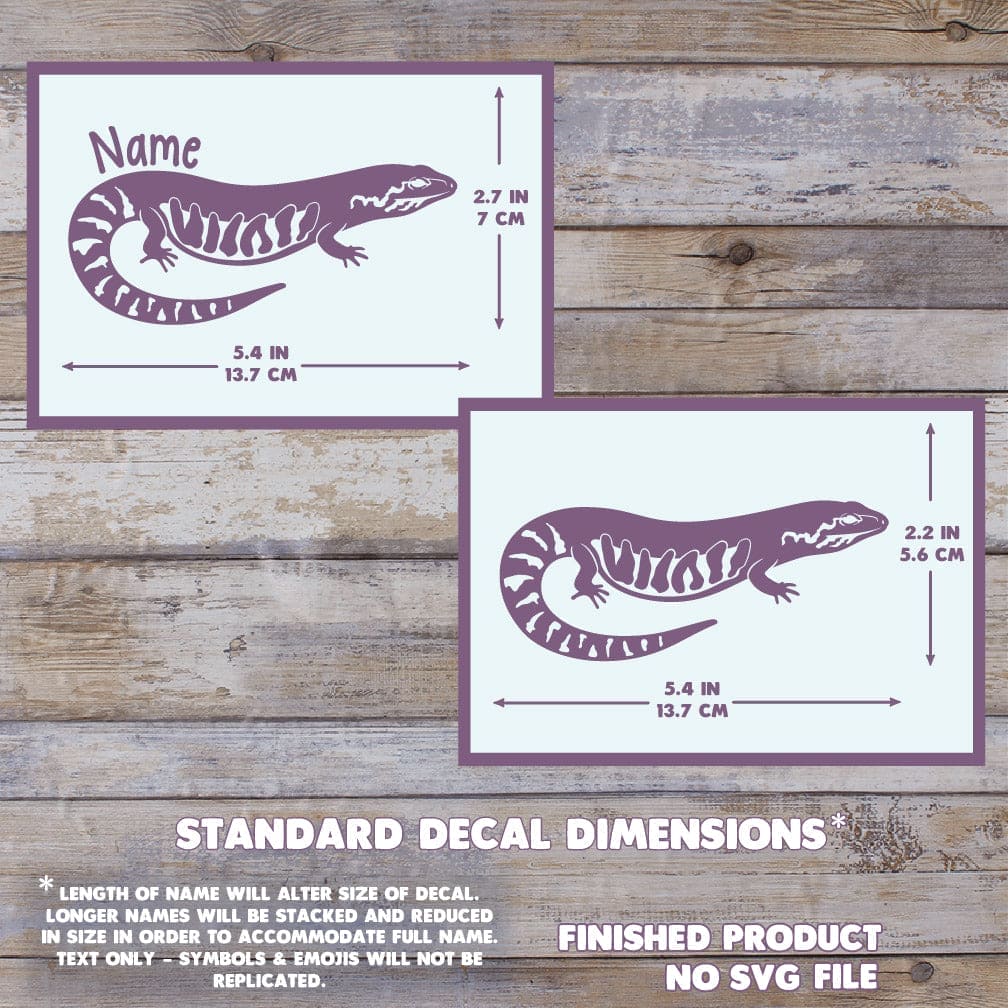 Two purple decals of fire skink lizards with dimensions on a wooden background. Measurement reads 2.7 inch tall by 5.4 inches wide.