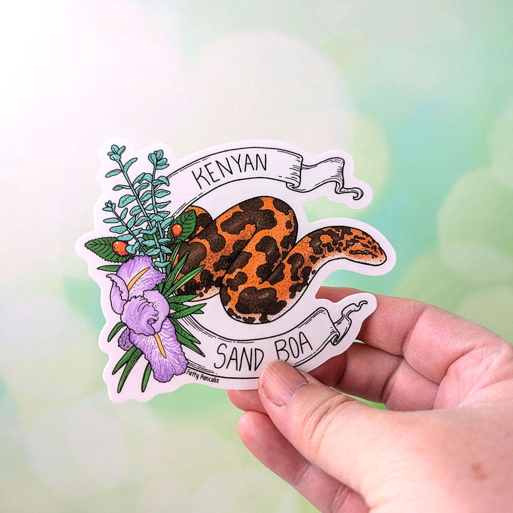 Hand holding vinyl sticker of kenyan sand boa to show scale. Sticker is 3.5" high.