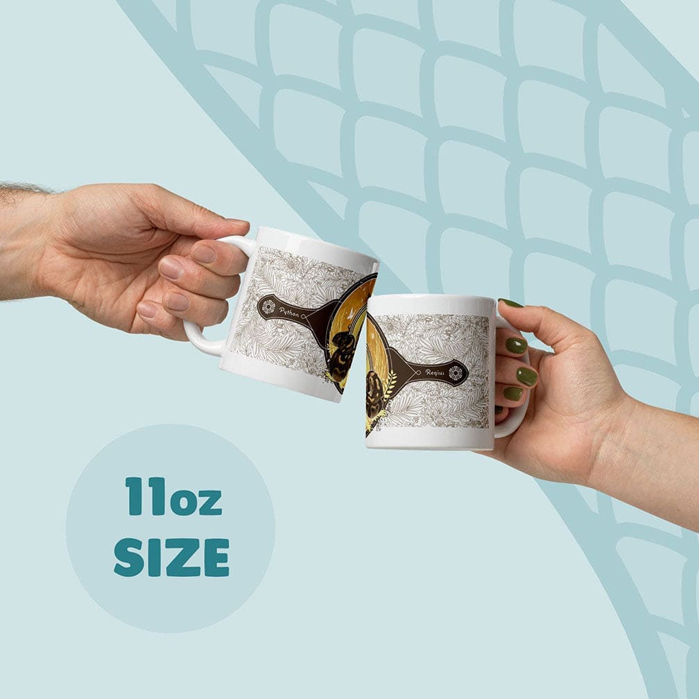 Two white 11oz ceramic mugs featuring a detailed graphic design with a central golden circular emblem, a dark silhouette of a snake, and intricate botanical line art patterns. The text on the mugs includes the words Python and Regius.