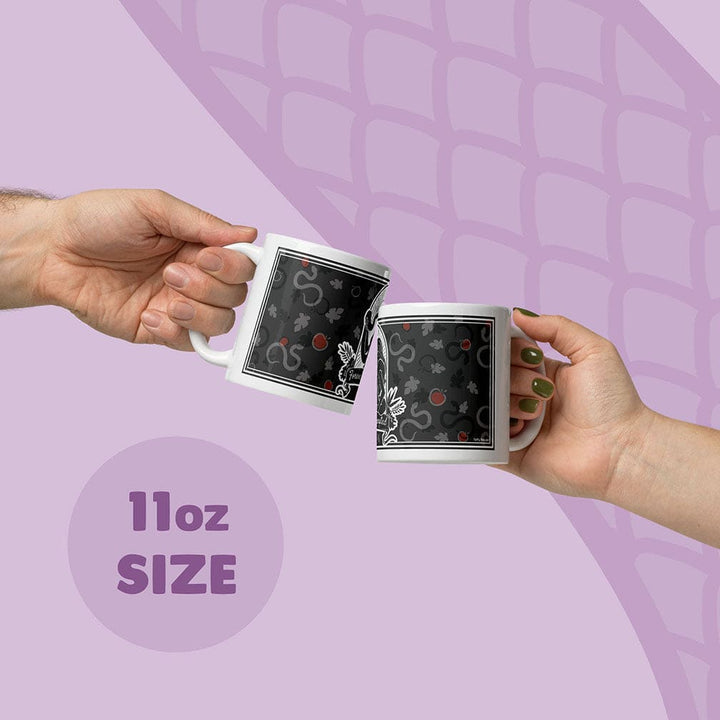 Two hands holding white ceramic mugs with a grey apple and snake pattern, clinking them together on a light purple graphic background with &