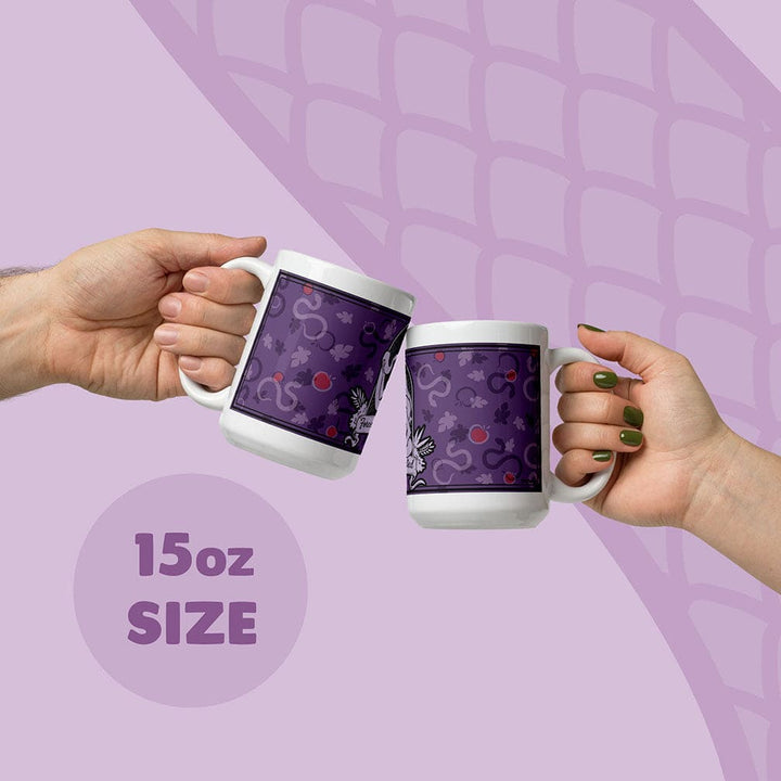 Two hands holding white ceramic mugs with a purple apple and snake pattern, clinking them together on a light purple graphic background with &