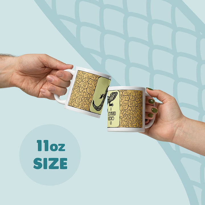 Two hands holding white ceramic mugs with a gold patterned design and a yellow-and-black leopard gecko graphic, clinking together against a light blue graphic background with &
