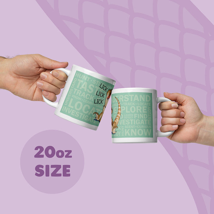Two white 20oz ceramic mugs being held up by two hands featuring a light green rectangular graphic with the text "HUNT, TASTE, TRACK, LOCATE, INVESTIGATE, UNDERSTAND, EXPLORE, FIND, KNOW" and an illustration of a bearded dragon lizard with the word "LICK".