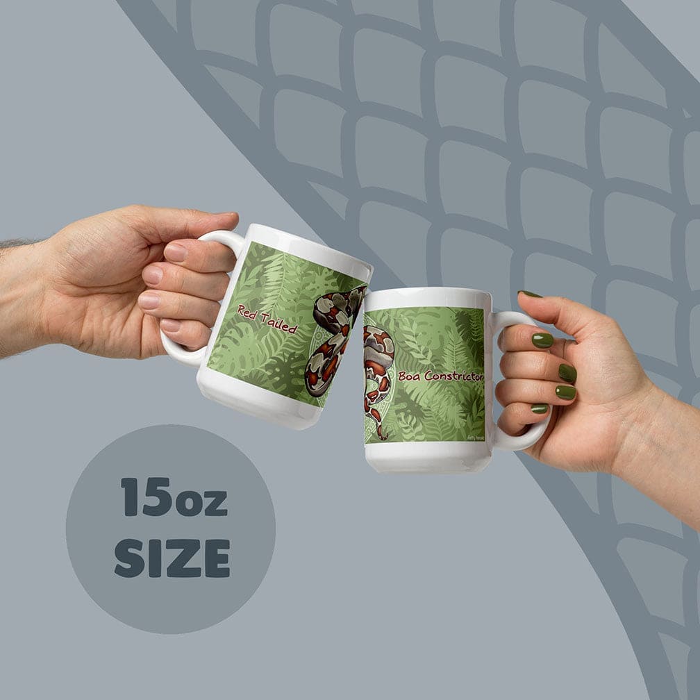 Two white ceramic mugs with an 15oz size capacity, each featuring a green fern leaf pattern and a red-tailed boa constrictor illustration. The text Red Tailed is printed on one mug and Boa Constrictor is printed on the other mug.