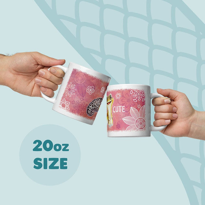 Two white ceramic mugs with a pink floral background and a leopard gecko illustration. The mugs feature the text OH CUTE and are labeled as 20oz size. The design includes white line-art flowers and a spotted gecko pattern on the surface.