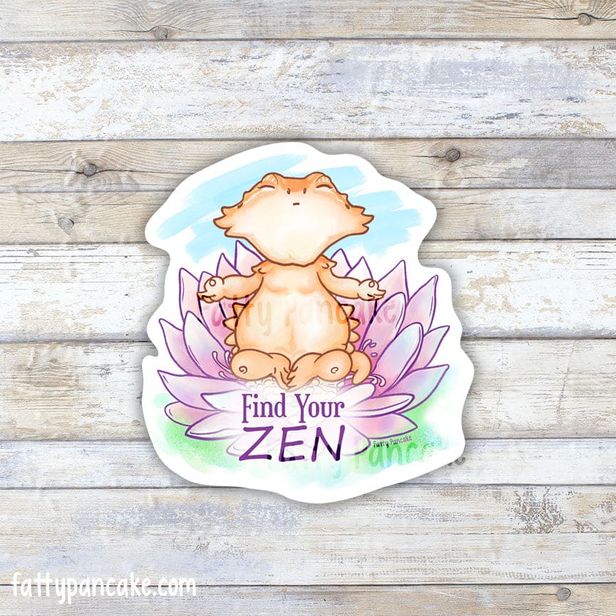 Vinyl sticker of a cartoon bearded dragon sitting in a lotus flower with soft, pastel colors, their pose meditating and the words, "Find your Zen" underneath them. 