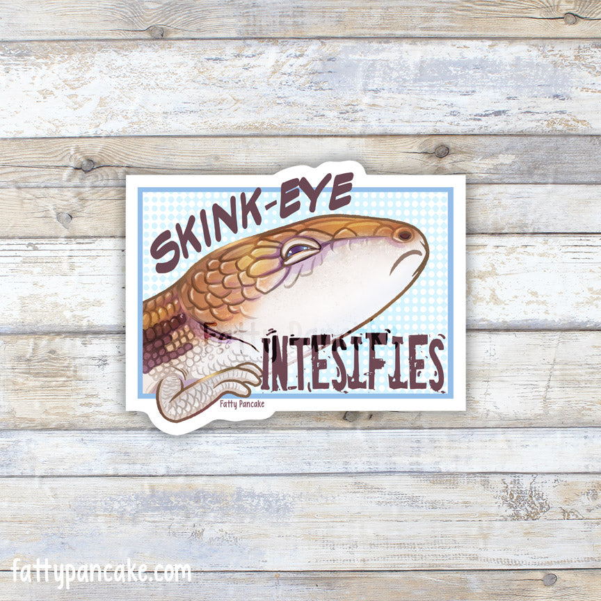 A die-cut sticker featuring a cartoon skink with the text &