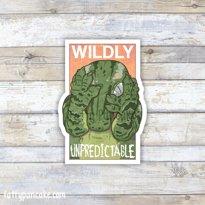 A die-cut sticker featuring a green leachie gecko peeking out from behind it&