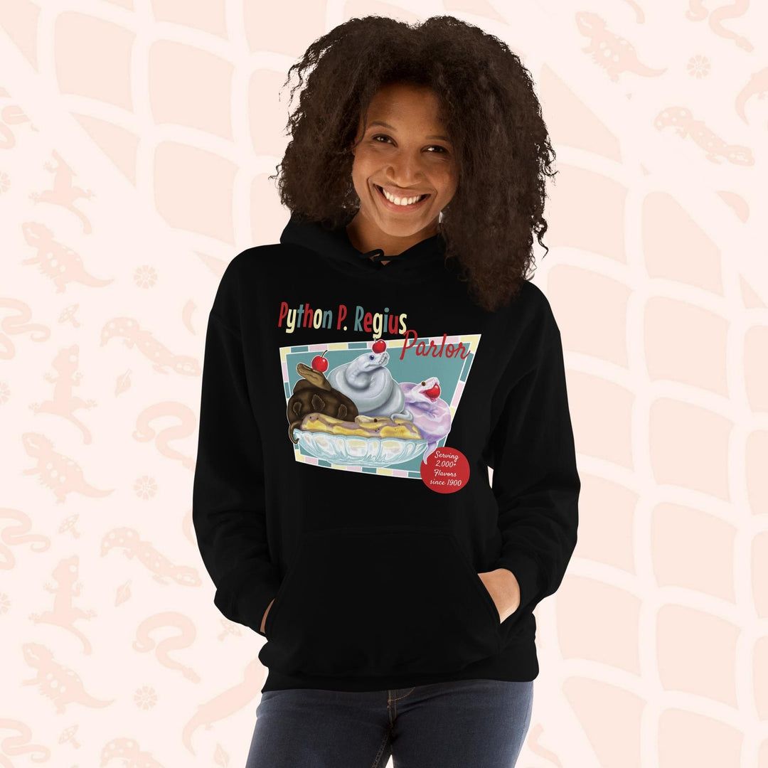 A black hoodie with a retro-style graphic of a sundae with three ball pythons on top. The graphic says "Python P. Regius Parlor" and "Serving 2,000+ flavors since 1990".