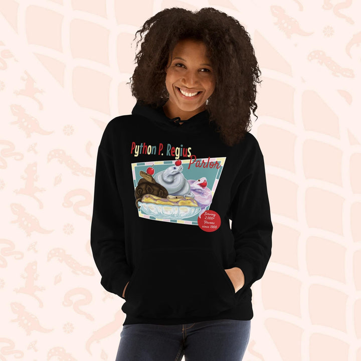 A black hoodie with a retro-style graphic of a sundae with three ball pythons on top. The graphic says "Python P. Regius Parlor" and "Serving 2,000+ flavors since 1990".