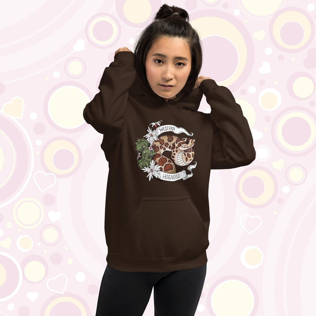 A woman wearing an chocolate brown colored hoodie with a line art with color hognose snake surrounded by a white banner with text that reads "Western Hognose". Cactus and white flowers are on the left side of the design.