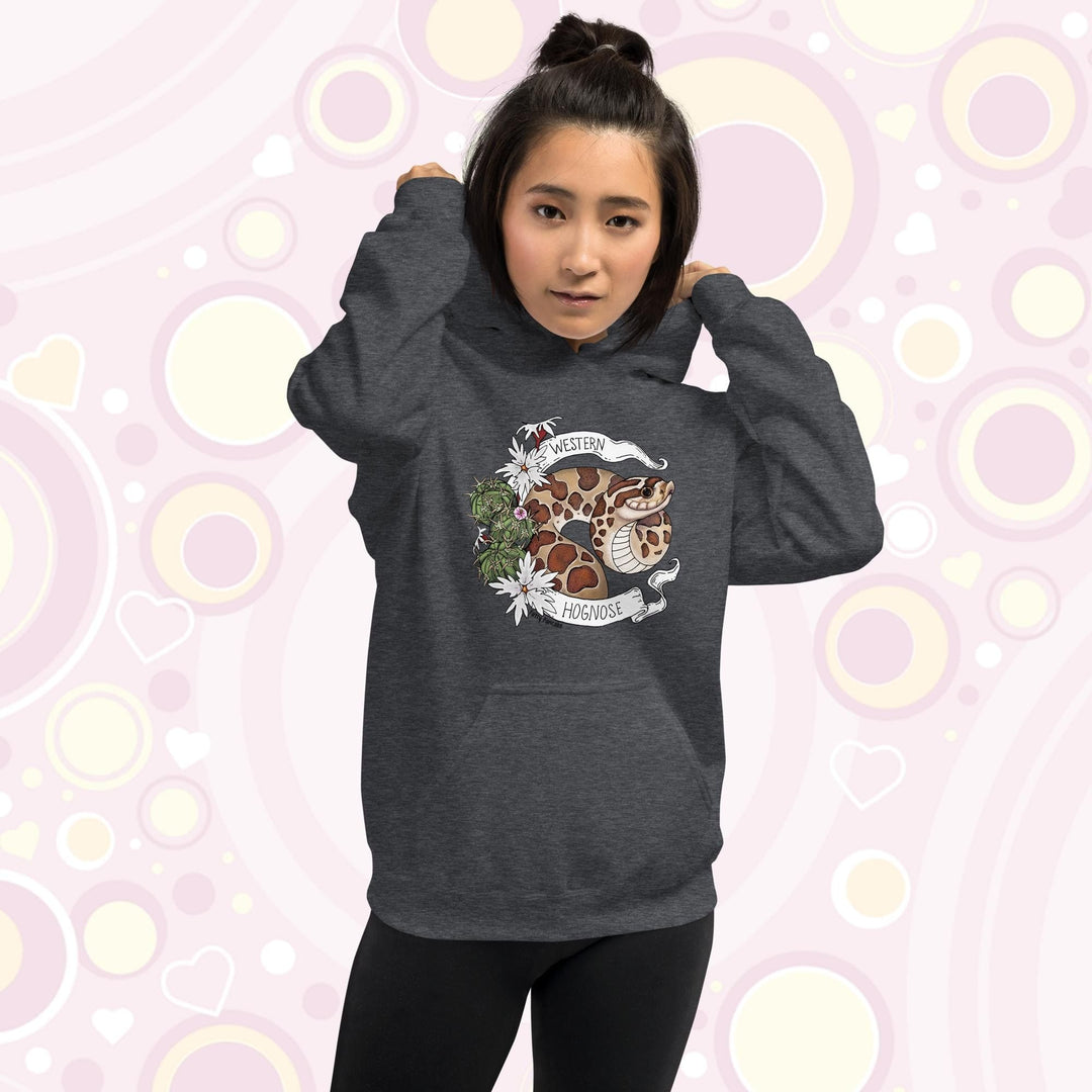 A woman wearing an heather grey colored hoodie with a line art with color hognose snake surrounded by a white banner with text that reads "Western Hognose". Cactus and white flowers are on the left side of the design.