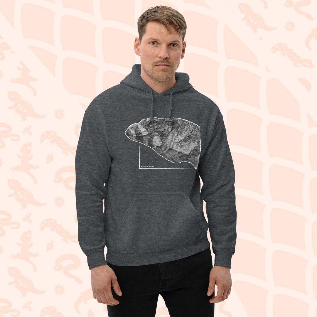 A man wearing a grey pullover hoodie with a graphic print of a pencil drawing of a lace monitor lizard. It's a profile view and highly detailed showing a close up of the scales. The hoodie has a front pocket.