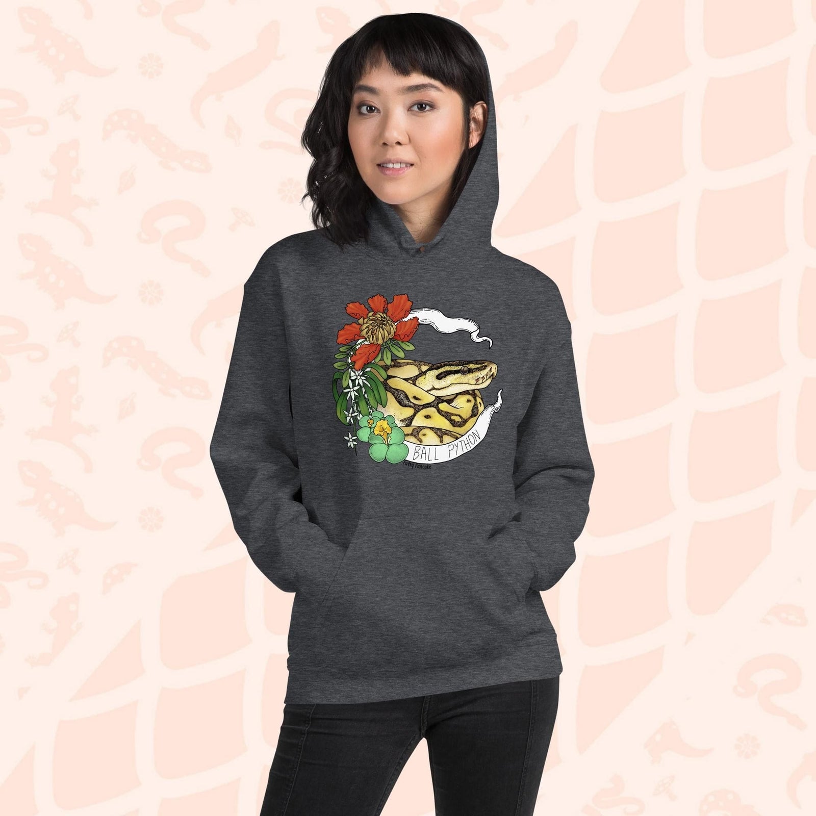 A dark grey hoodie with a graphic of a ball python snake with flowers and the text "Ball Python" on a white banner.