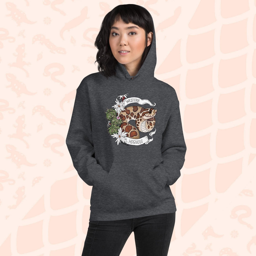 A woman wearing an heather grey colored hoodie with a line art with color hognose snake surrounded by a white banner with text that reads "Western Hognose". Cactus and white flowers are on the left side of the design.
