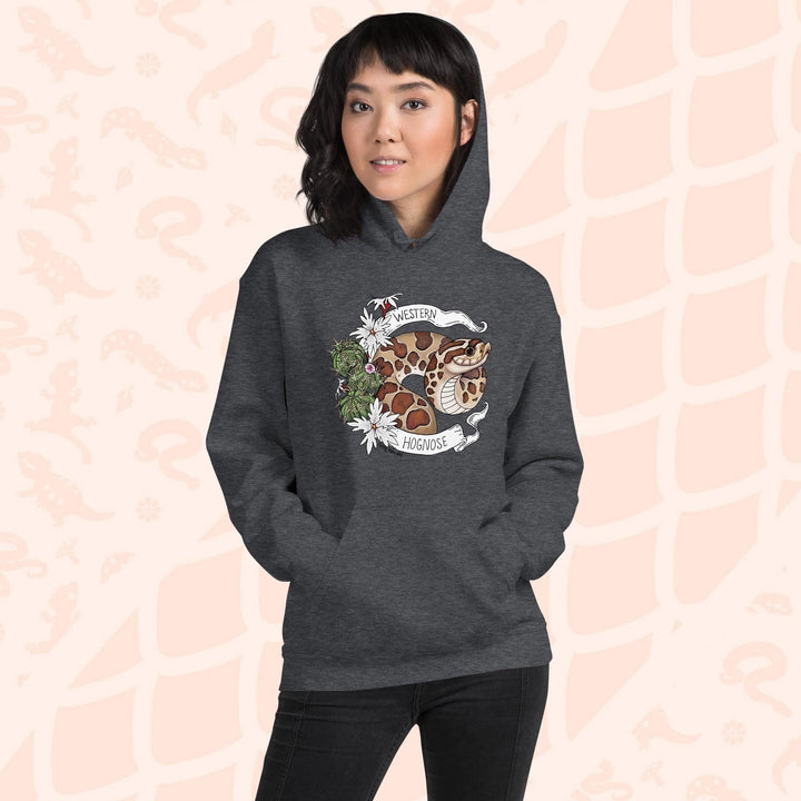 A woman wearing an heather grey colored hoodie with a line art with color hognose snake surrounded by a white banner with text that reads "Western Hognose". Cactus and white flowers are on the left side of the design.