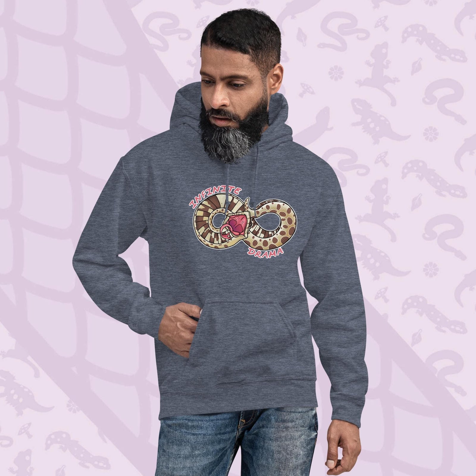 A man wearing a grey pullover hood with a silly cartoon graphic of a hognose in a figure "8" shape. It's tail is draped over it's head in a dramatic fashion and the text Infinite Drama is placed on opposite sides of the snakes body. The hoodie is made of cotton and has a front pouch sewn in.