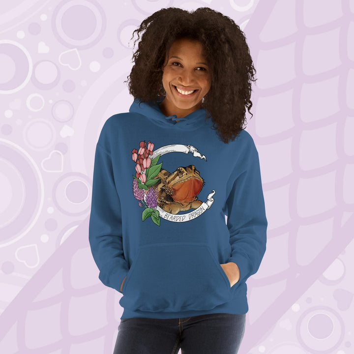 A woman wearing a neutral blue hooded sweatshirt with a graphic of a bearded dragon with pink flowers and the text "Bearded Dragon".