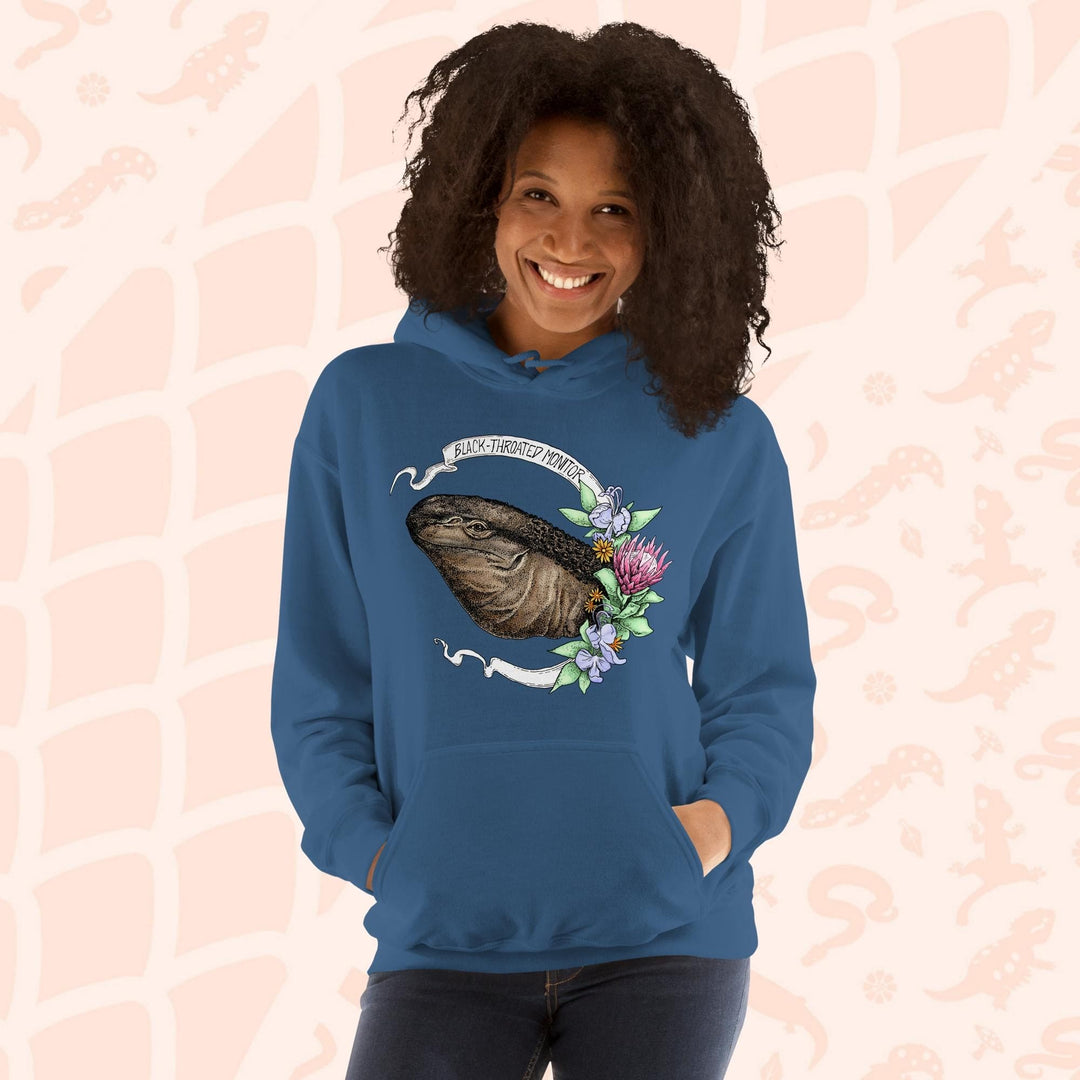 A neutral blue hooded sweatshirt with a graphic of a black-throated monitor lizard with flowers and the text "Black-throated Monitor" on a white banner.