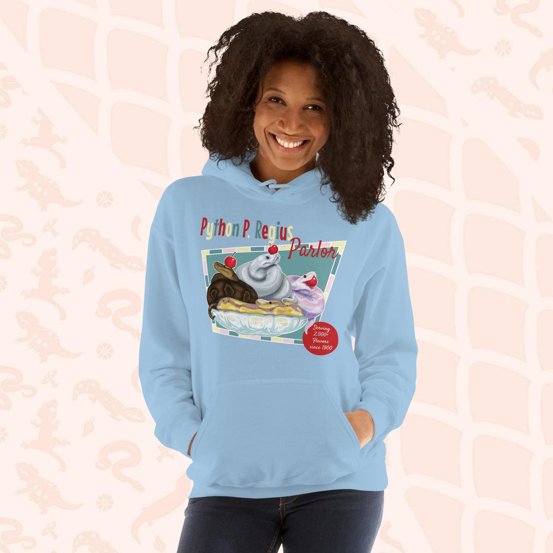 A light blue hoodie with a retro-style graphic of a sundae with three ball pythons on top. The graphic says "Python P. Regius Parlor" and "Serving 2,000+ flavors since 1990".
