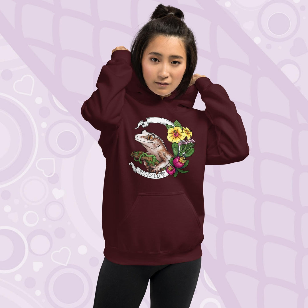 Maroon red hoodie with a graphic of a crested gecko with flowers and the text "Crested Gecko".