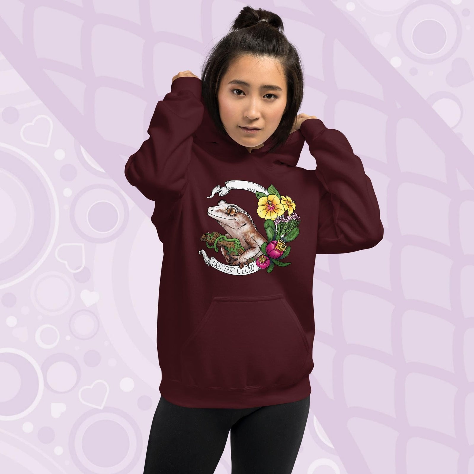 Maroon red hoodie with a graphic of a crested gecko with flowers and the text "Crested Gecko".