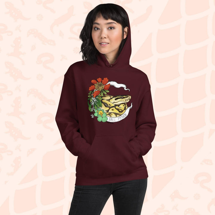 A deep red maroon hoodie with a graphic of a ball python snake with flowers and the text "Ball Python" on a white banner.