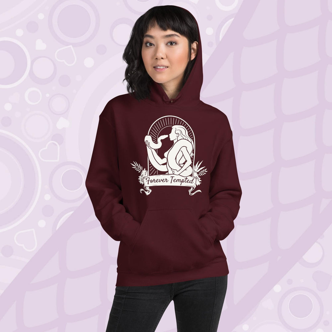 Woman wearing a deep red maroon hoodie with a white graphic of a silhouetted woman with a snake wrapped around her. Her hand holds up the snakes head and they are staring at each other. The graphic is in an arch with the text "Forever Tempted" on a banner below.