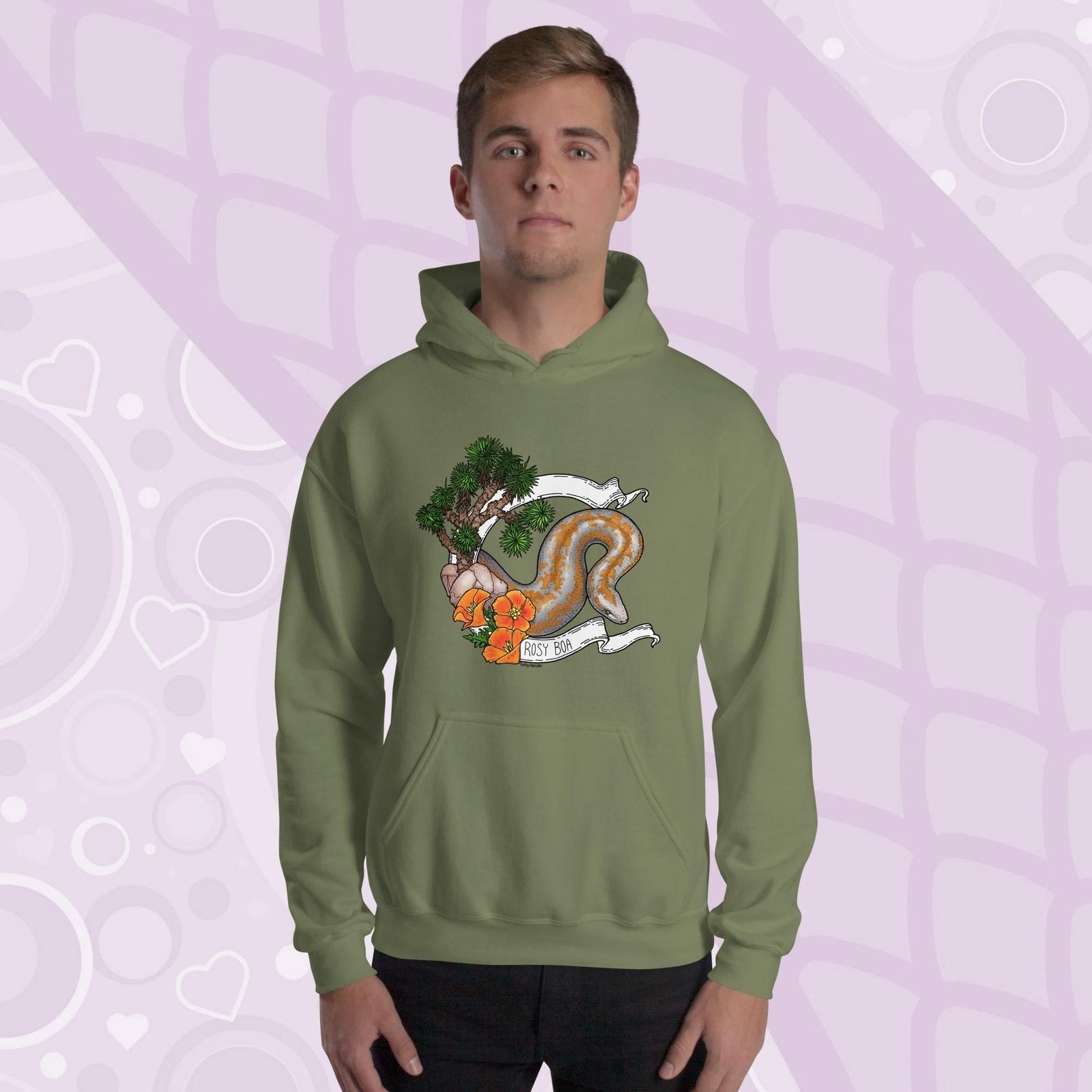 A man wearing an olive green colored pullover hoodie with a design of an american rosy boa snake with california poppy flowers and a few joshua trees on the left side of the design. The hoodie is cotton material with a front pocket sewn in the front.