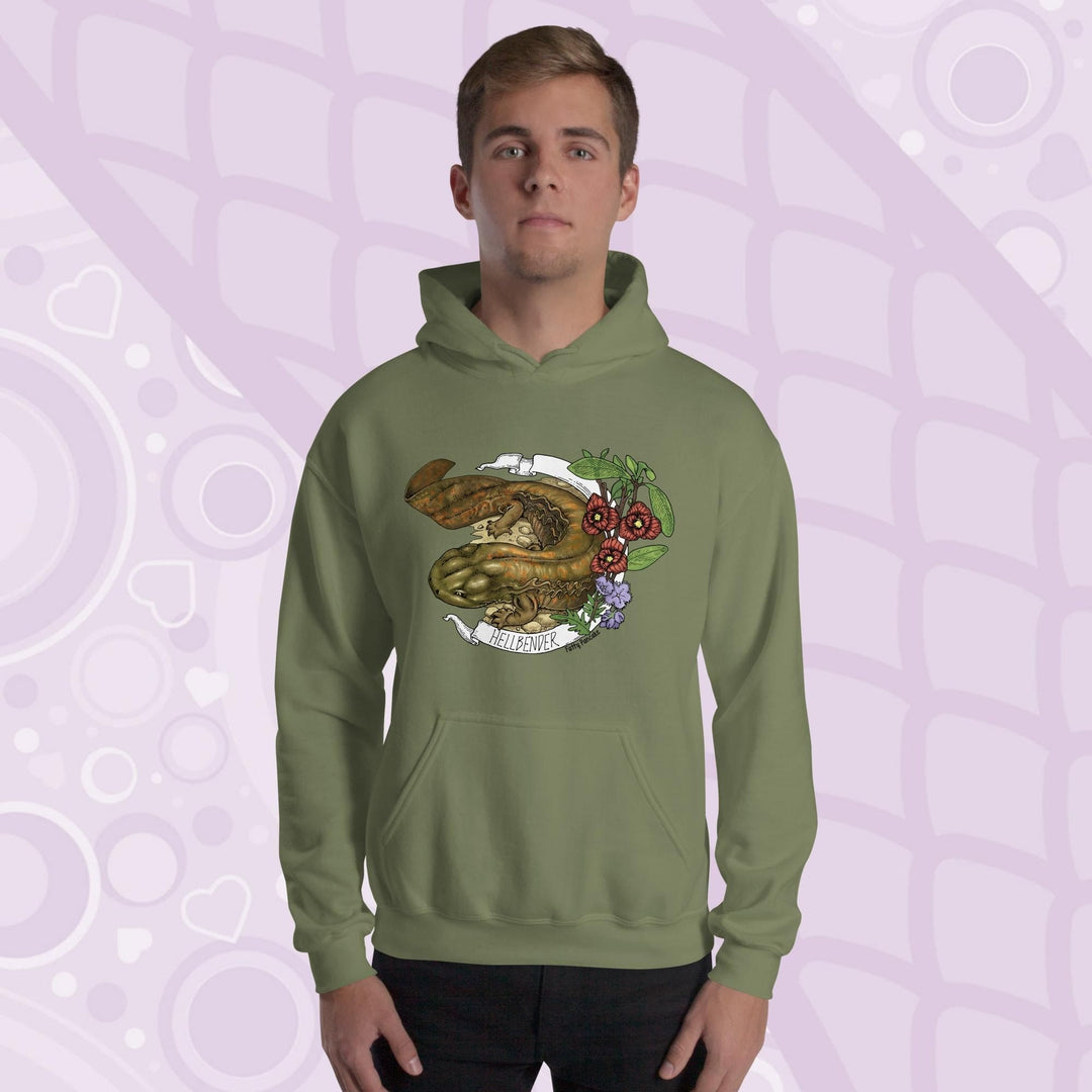 A man wearing a olive green hoodie featuring a detailed illustration of a salamander with the text "HELLBENDER" in white. The design includes floral elements in red, green, and purple. The hoodie has a front pocket and a hood.