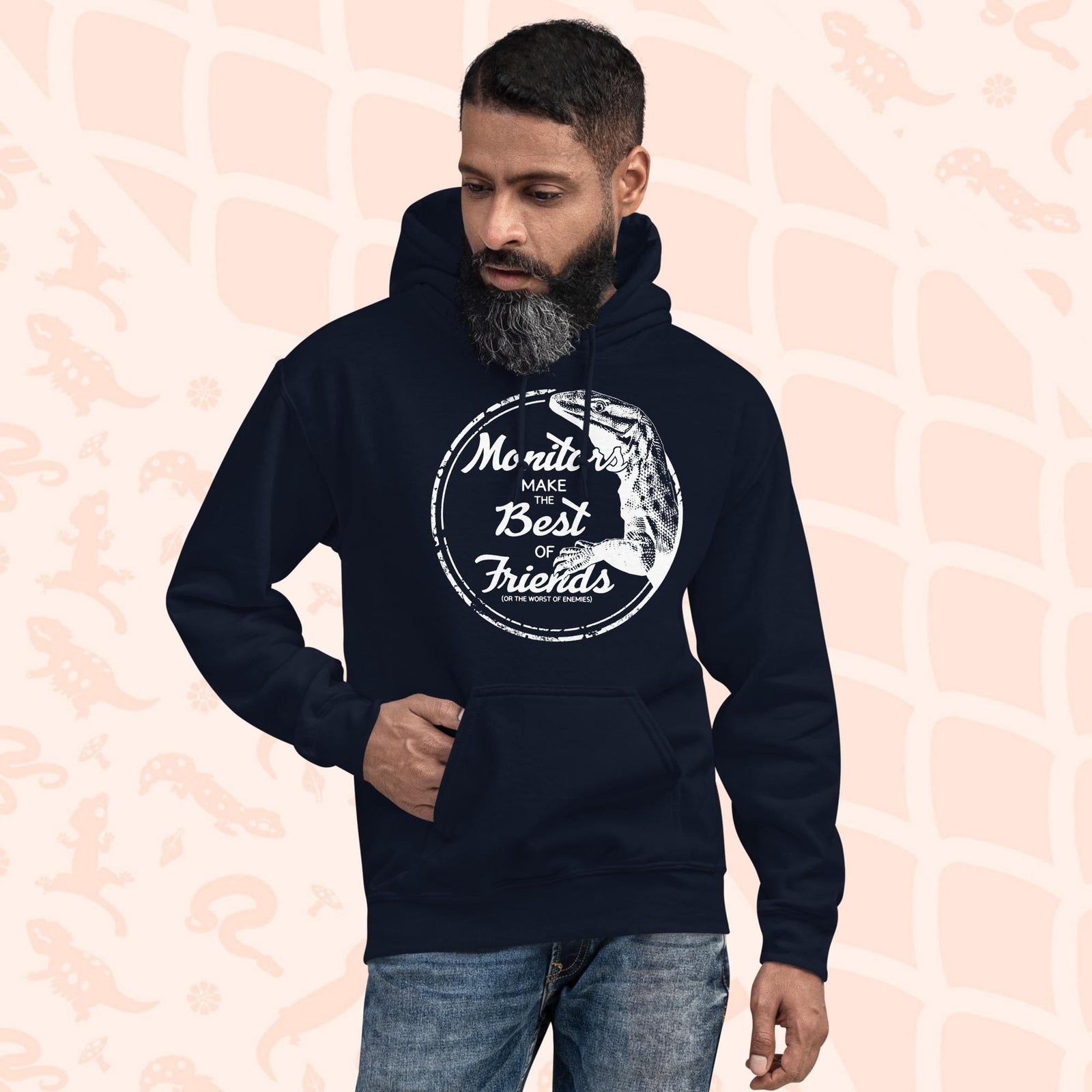 Man wearing a navy blue hoodie with a white graphic of an ackie monitor lizard and the text "Monitors Make the Best of Friends" in a circle.