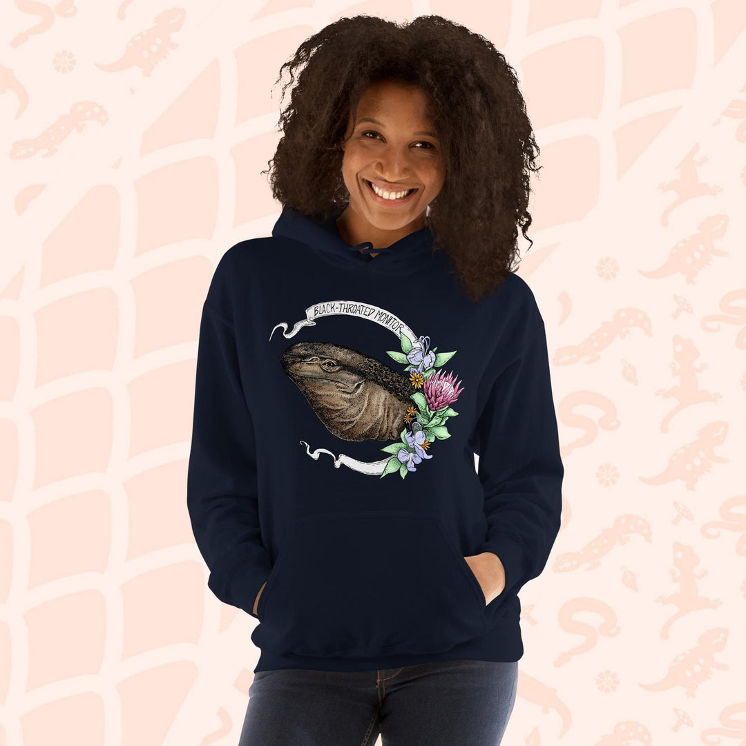 A navy blue hooded sweatshirt with a graphic of a black-throated monitor lizard with flowers and the text "Black-throated Monitor" on a white banner.