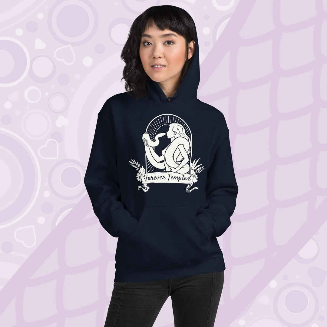 Woman wearing a navy blue hoodie with a white graphic of a silhouetted woman with a snake wrapped around her. Her hand holds up the snakes head and they are staring at each other. The graphic is in an arch with the text "Forever Tempted" on a banner below.