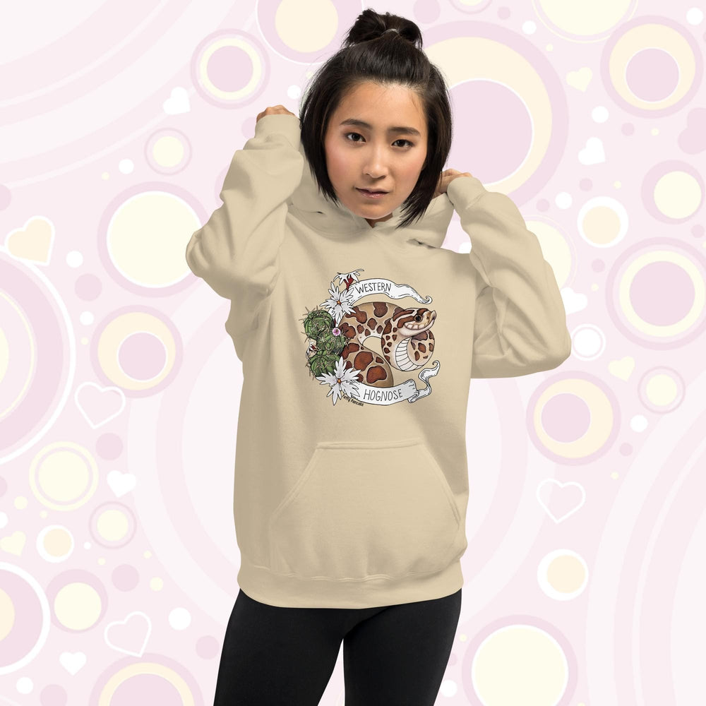 A woman wearing an cream colored hoodie with a line art with color hognose snake surrounded by a white banner with text that reads "Western Hognose". Cactus and white flowers are on the left side of the design.