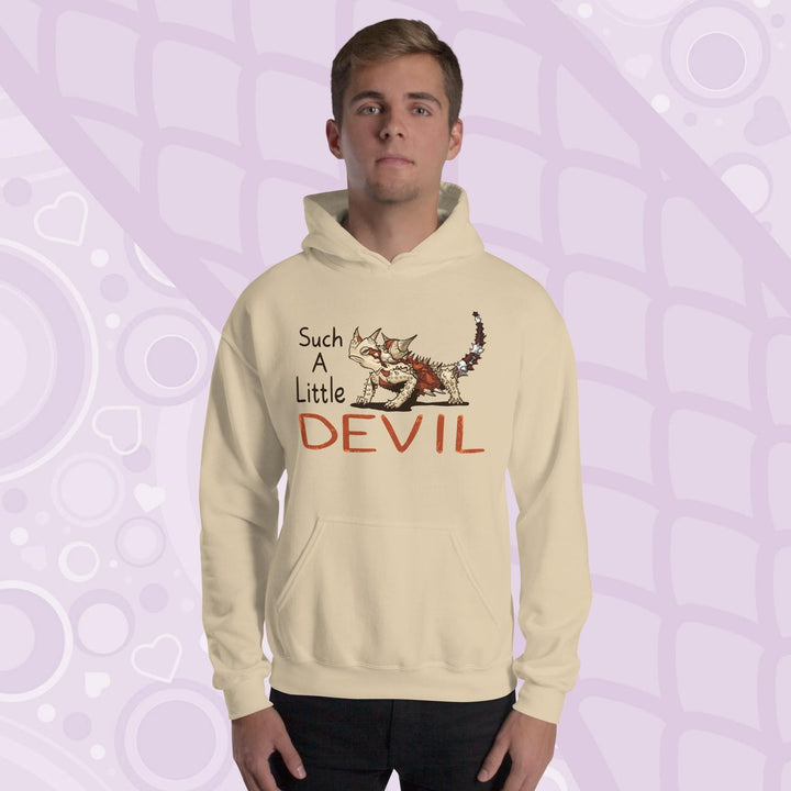 A soft tan hoodie with a cartoon Australian Thorny Devil lizard. It is very spiny and has a grouchy face, with tan and red colors and facing left with large text to it's left that states "Such A Little DEVIL" printed on the front. The hoodie is soft cotton with a front pouch.