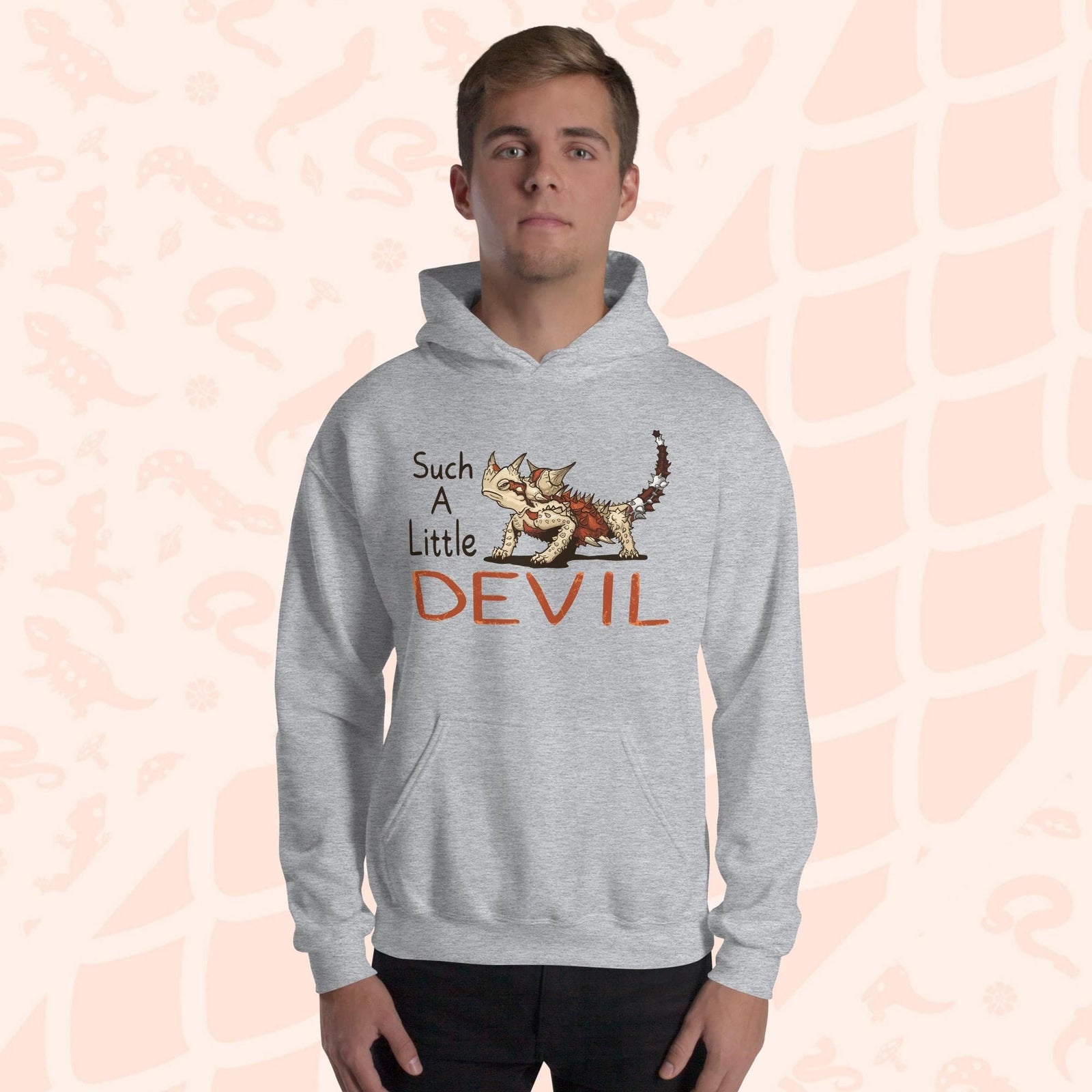 A gray hoodie with a cartoon Australian Thorny Devil lizard. It is very spiny and has a grouchy face, with tan and red colors and facing left with large text to it's left that states "Such A Little DEVIL" printed on the front. The hoodie is soft cotton with a front pouch.